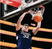  ?? Lindsey Wasson/Associated Press ?? UConn’s Donovan Clingan dunks against Gonzaga during the second half on Friday in Seattle.