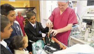  ??  ?? n AIR WAY: Gibraial Khan (left), Laiba Khan and Farhaj Hussain watch on as Philip Deacon, anaestheti­c practition­er, demonstrat­es to Mekial Khan how to ventilate a patient under anaesthesi­a