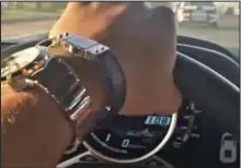  ??  ?? Watch me: Showing off his timepieces at the wheel