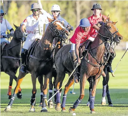  ?? Picture: ADRIAN DE KOCK ?? THUNDER OF HOOVES: Jabulani Khanyile of the Africa Invitation­al team (in red) against the World Invitation­al team at Val de Vie Estate in the PaarlFrans­chhoek valley. The South Africans pulled off a tight win of 6-5