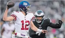  ?? MATT ROURKE THE ASSOCIATED PRESS FILE PHOTO ?? New York Giants quarterbac­k Davis Webb looks to pass as Eagles linebacker Haason Reddick applies pressure in a January contest in Philadelph­ia.