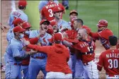  ?? AARON DOSTER — THE ASSOCIATED PRESS ?? The St. Louis Cardinals’ Nolan Arenado, center left, reacts alongside teammate catcher Yadier Molina, center, as they scrum with members of the Cincinnati Reds during the fourth inning Saturday in Cincinnati.