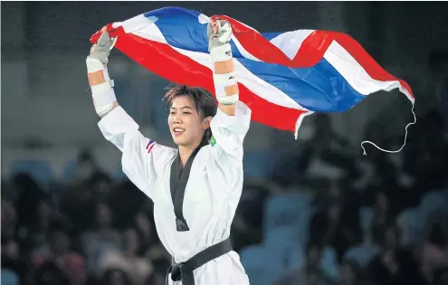  ??  ?? Panipak Wongpattan­akit celebrates after winning a bronze medal at the 2016 Olympics.