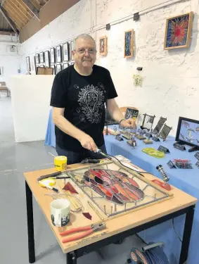  ??  ?? Glass act Alan Lewis is an expert in stained glass, and copper and silver jewellery