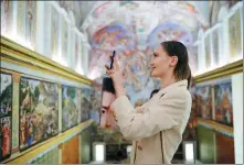  ?? PHOTOS PROVIDED TO CHINA DAILY ?? Left: The Artist is Present exhibition at Yuz Museum in Shanghai provides a novel perspectiv­e on what’s happening in the world. Right: Maurizio Cattelan’s work, Untitled, reproduces the interior of the Sistine Chapel.