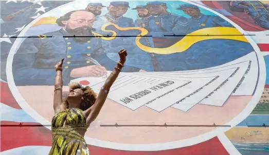  ?? STUART VILLANUEVA/THE GALVESTON COUNTY DAILY NEWS VIA AP ?? Dancer Prescylia Mae performs Saturday during a dedication ceremony for the massive mural “Absolute Equality” in downtown Galveston, Texas. The dedication of the mural, which chronicles the history and legacy of Black people in the U.S., was one of several Juneteenth celebratio­ns across the city.