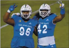  ?? JOHN LOCHER — THE ASSOCIATED PRESS ?? San Jose State defensive lineman Jay Kakiva (96) and defensive end Viliami Fehoko (42) celebrate the Spartans’ win over Nevada this month.