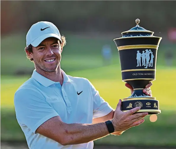  ?? — aFP ?? rory McIlroy posing with his trophy after winning the WGC-HSbC Champions tournament in Shanghai yesterday. All smiles: