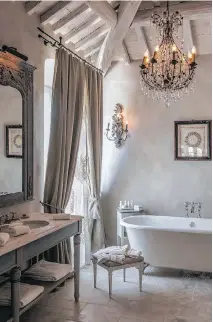  ??  ?? ABOVE: Details of a bathroom in the Unicorno Garden Suite at the Borgo Santo Pietro Hotel in Tuscany, Italy. In this charming hotel, romantic and elegant accessorie­s such as art, curtains and lighting add warmth to the space.