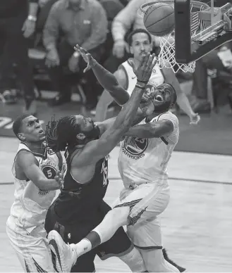  ?? Michael Ciaglo / Houston Chronicle ?? Rockets center Nene tries to put up a shot against Warriors forward Draymond Green, right, and forward Kevon Looney. Nene was held scoreless in Monday night’s Game 1.