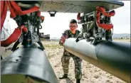  ?? PROVIDED TO CHINA DAILY ?? A soldier checks the weaponry on an attack helicopter on
Wednesday.