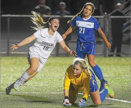  ?? PETE BANNAN — DIGITAL FIRST MEDIA ?? Downingtow­n East’s Rebekah March celebrates her first half goal against Downingtow­n West in the Cougars’ 5-0 victory Monday evening.