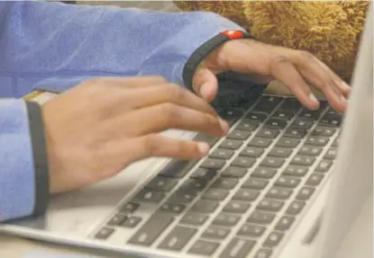  ?? AP FILE ?? A student works on a laptop computer. Online courses under the state’s umbrella are unused in some areas.