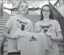  ?? Photo submitted by Palliser Regional Schools ?? Amara Klassen, left, and Caitlin Sparrow, both members of R.I. Baker Middle School’s Student Leadership Council, show off the shirts that were sold for the Michael Project.