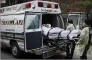 ?? JOHN MINCHILLO — THE ASSOCIATED PRESS ?? A patient is loaded into an ambulance by emergency medical workers outside Cobble Hill Health Center on April 17 in the Brooklyn borough of New York.