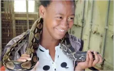  ??  ?? SNAKE CHARMER: A pupil unwinds as she participat­es in a snake show during one of Adopt-a-Pet’s Humane Education Programmes.