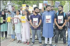  ?? HT PHOTO ?? Kashmiri students organise a silent protest at Aligarh Muslim University campus on Tuesday.