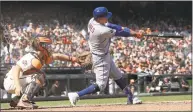  ?? Jeff Chiu / Associated Press ?? New York Mets’ Wilmer Flores, right, hits a double in front of San Francisco Giants catcher Nick Hundley during the first inning in San Francisco on Saturday. The Mets won 2- 1 in 11 innings.