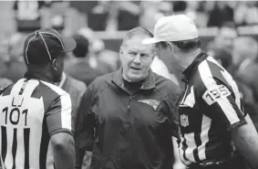  ?? DAVID J. PHILLIP/ THE ASSOCIATED PRESS ?? New England coach Bill Belichick and officials chat before Sunday’s game against Houston. Belichick wants the league to grant coaches more freedom to challenge referees’ calls.