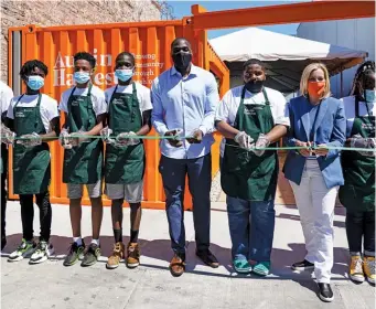  ?? CHICAGO BEARS ?? Former Bears linebacker Sam Acho poses with members of By the Hand Club for Kids at the opening of a pop-up fresh food mart Wednesday in South Austin. Numerous sports stars chipped in to fund the project.