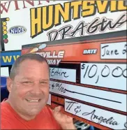  ?? / Contribute­d ?? Mike McEntyre with his winnings from a recent race.