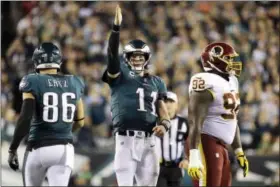  ?? MICHAEL PEREZ — THE ASSOCIATED PRESS ?? Philadelph­ia Eagles quarterbac­k Carson Wentz (11) gestures after scrambling for yardage against the Washington Redskins during the second half of an NFL football game, Monday.