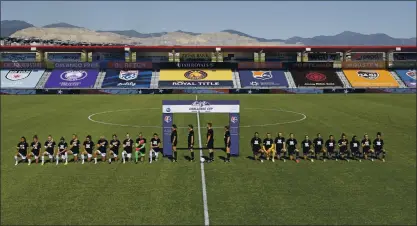  ?? PHOTOS BY RICK BOWMER – THE ASSOCIATED PRESS ?? Players for the Portland Thorns, left, and the North Carolina Courage kneel during the national anthem before their NWSL Challenge Cup match Saturday. The league said it would support the players in however they decided to use their platform to advocate for social justice.