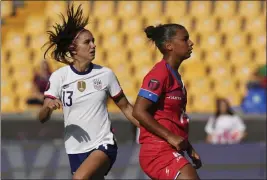  ?? PHOTOS BY FERNANDO LLANO — THE ASSOCIATED PRESS ?? SOCCER
Alex Morgan, left, watches the ball go into the net as she scores the second of her two first-half goals in the United States’ 3-0win over Haiti in a CONCACAF match Monday.