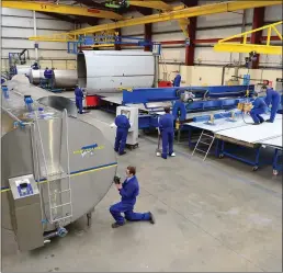  ?? Dairymaste­r workers on the factory’s main production floor where the company’s products are assembled. ??