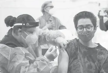  ?? ALLEN J. SCHABEN/LOS ANGELES TIMES ?? A nurse gives a student a COVID-19 vaccine at Eagle Rock High School in Los Angeles.