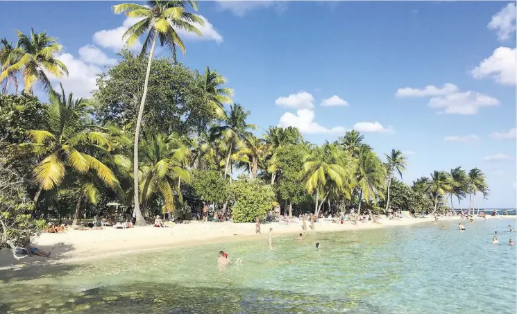  ?? MAURA JUDKIS/THE WASHINGTON POST ?? Visitors enjoy the sun, sand and warm water of Plage de la Caravelle, a beach on Guadeloupe’s Grande-Terre island.