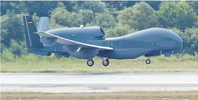  ?? ARMIN WEIGEL/AFP/GETTY IMAGES ?? The unmanned Euro Hawk plane lands at the airbase in Manching, Germany, after a non-stop flight from California. Transport Canada is reportedly considerin­g buying the drones for Arctic surveillan­ce.