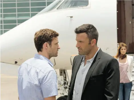  ?? SCOT T GARFIELD/AP PHOTO ?? Justin Timberlake, left, and Ben Affleck in a scene from Runner Runner, a film that looks at the dark side of online gambling.