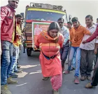  ?? PTI ?? Tamil Nadu’s Rajalaxmi Manda, who has achieved several feats demonstrat­ing physical strength, pulls a truck during a BJP election campaign rally in Bikaner, Rajasthan, on Thursday. —