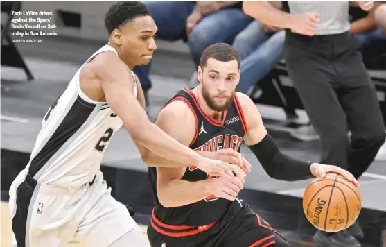  ?? DARREN ABATE/AP ?? Zach LaVine drives against the Spurs’ Devin Vassell on Saturday in San Antonio.