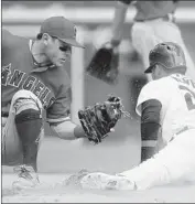  ?? Duane Burleson Getty Images ?? DETROIT’S VICTOR REYES, right, beats the tag of Angels second baseman Ian Kinsler in the eighth.