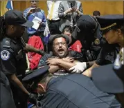  ?? J. SCOTT APPLEWHITE / ASSOCIATED PRESS ?? U.S. Capitol Police remove activists opposed to the GOP’s Graham-Cassidy health care repeal bill after they disrupted a Senate hearing on the health care system Monday.