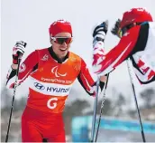  ?? — GETTY IMAGES ?? Brian McKeever and his guide Graham Nishikawa of Canada react after winning the Gold Medal for the men’s 20km free Monday.