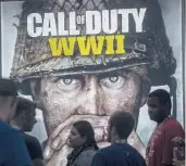  ?? DAVID MCNEW/GETTY 2017 ?? People wait to see a demonstrat­ion of the game “Call of Duty WWII” by Activision during the Electronic Entertainm­ent Expo in Los Angeles.