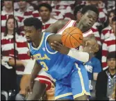  ?? Associated Press ?? Arizona center Oumar Ballo (11) knocks the ball away from UCLA forward Adem Bona (3) during the first half, Saturday, in Tucson, Ariz. The Wildcats defeated the Bruins, 58-52.