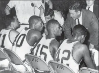  ?? THE ASSOCIATED PRESS FILE ?? Loyola coach George Ireland, right, bends over to issue orders to his team that was trailing Cincinnati in the 1963 NCAA championsh­ip game at Louisville, Ky. Players, from left to right, are: John Egan, Vic Rouse, Jerry Harkness and Ron Miller. The Ramblers play Nevada on Thursday after two thrilling wins to reach the Sweet 16, earning more wins this season than the team that won the 1963 title.