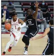  ?? (NWA Democrat-Gazette/Andy Shupe) ?? Arkansas guard JD Notae (1) drives the baseline Saturday while being guarded by UCA forward Eddy Kayouloud during the Razorbacks’ victory over the Bears. Notae finished with a game-high 22 points.