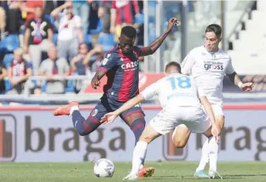  ?? Associated Press ?? ±
Bologna’s Musa Barrow (left) kicks the ball past Empoli’s Razvan Marin during their match on Saturday.