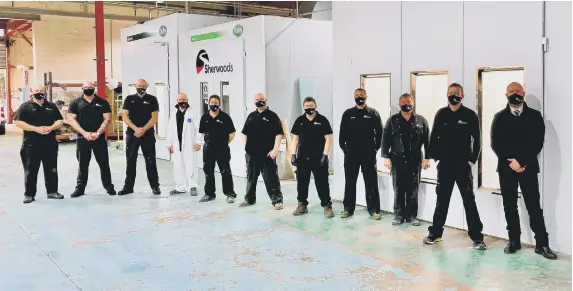  ??  ?? Sherwoods’ Bodyshop manager Marc Madden with his team in front of the new spray booths.