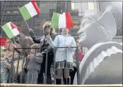  ?? SETH WENIG — THE ASSOCIATED PRESS FILE ?? People ride on a float with a large bust of Christophe­r Columbus during the Columbus Day parade in New York.