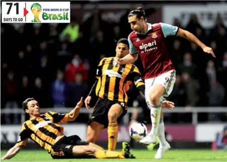  ??  ?? Andy Carroll of West Ham leaps over the tackle of James Chester of Hull City during the Barclays Premier League match at Boleyn Ground on March 26, 2014