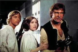  ?? THE ASSOCIATED PRESS ?? Mark Hamill as Luke Skywalker, Carrie Fisher as Princess Leia Organa, and Harrison Ford as Hans Solo in the original 1977 "Star Wars".