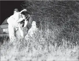  ?? CHRISTOPHE­R FURLONG/GETTY PHOTO ?? A police forensic scientist documents evidence at the site on Queen Elizabeth II’S Sandringha­m estate where the body of a young woman was found Jan. 1.