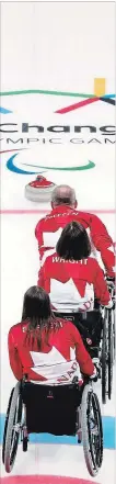  ?? SCOTT GRANT THE CANADIAN PRESS ?? Canada curlers watch the rock glide down the ice as they play compete in wheelchair curling during the 2018 Paralympic Winter Games in Pyeongchan­g, South Korea.