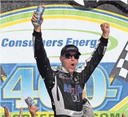  ??  ?? Kevin Harvick celebrates Sunday after winning the Consumers Energy 400 at Michigan Speedway. The Stewart-Haas Racing driver finished more than a second ahead of Denny Hamlin.